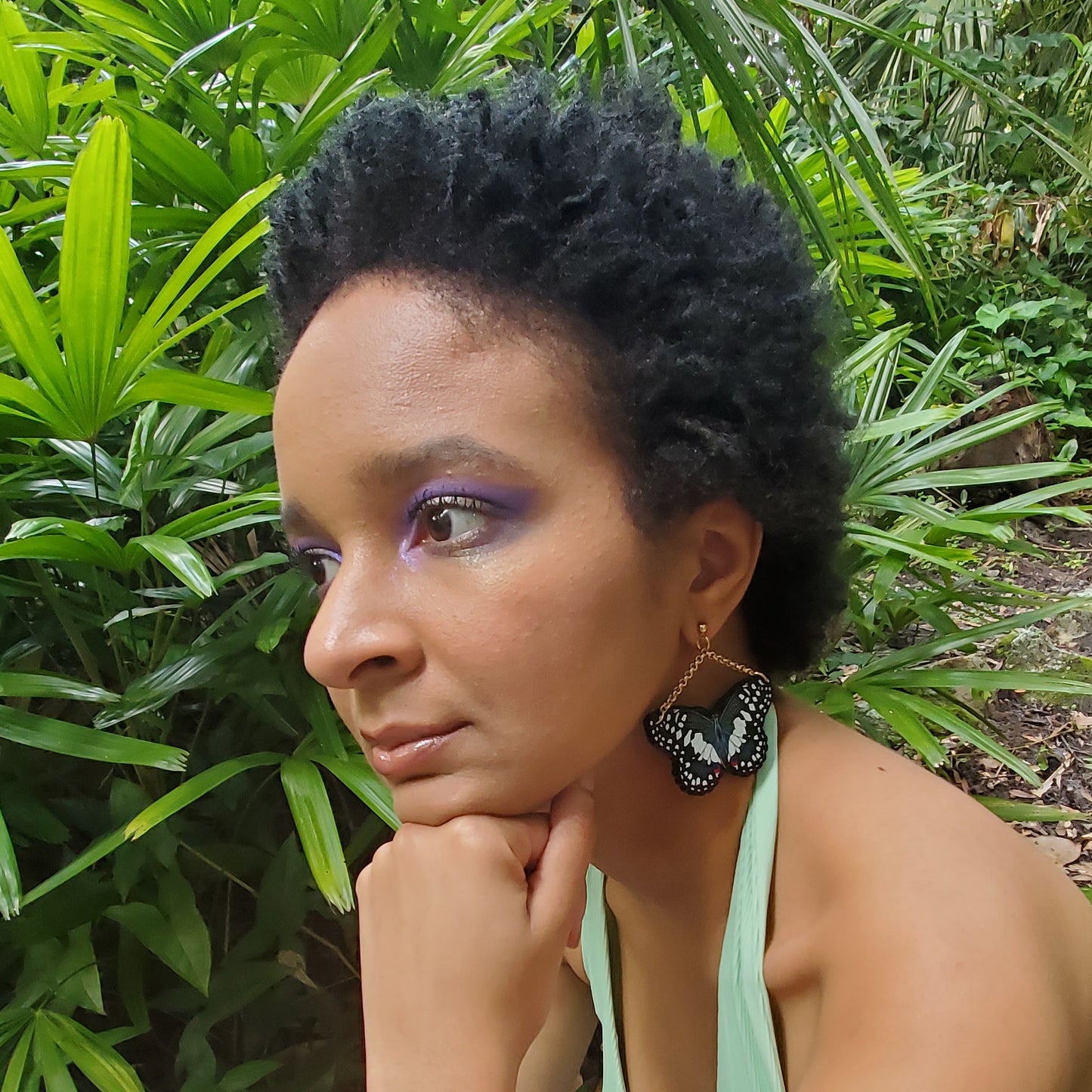 girl wearing medium sized black butterfly earrings 